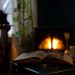 Reading a book by the fireplace in winter