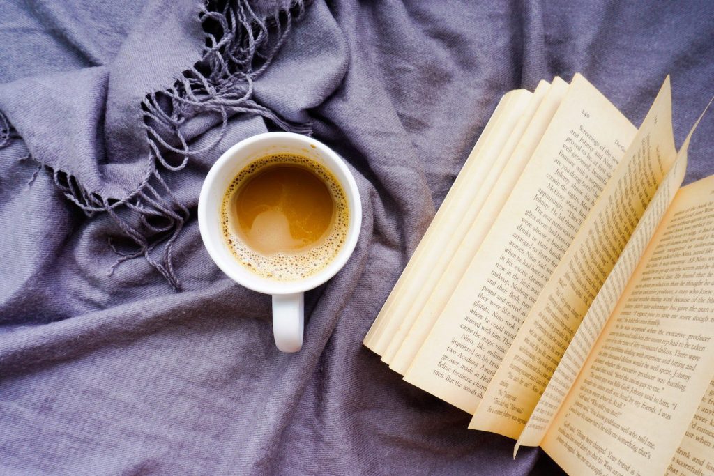 Book by cup of coffee